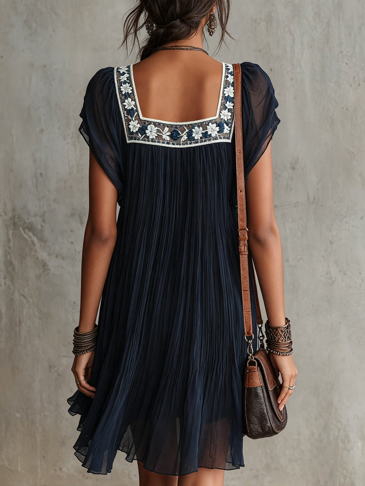 Grace | Pleated Satin Mini Dress with Navy Floral Embroidery